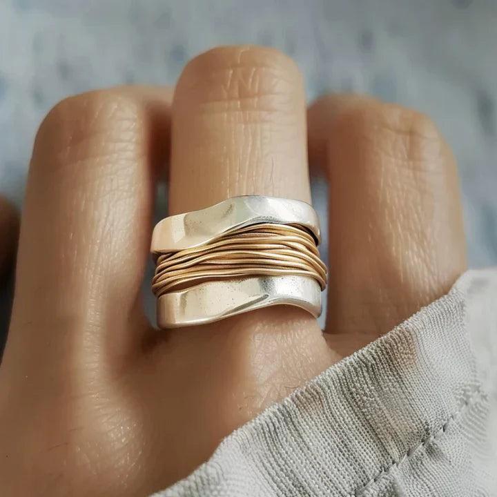 Silberring mit gewelltem Design und goldenen Akzenten, moderner Schmuck, Unisex-Ring.