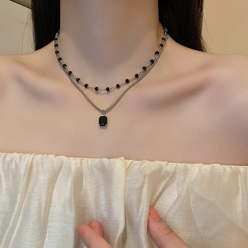 Doppelte Halskette mit schwarzem Anhänger, elegantes Design, Damenmode, Schmuckaccessoire.