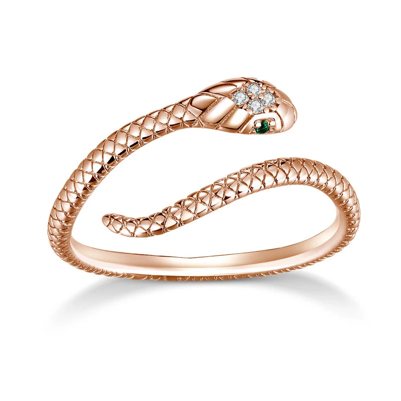 Schlangenring aus Roségold mit Diamanten und Smaragden, elegantes Schmuckdesign.