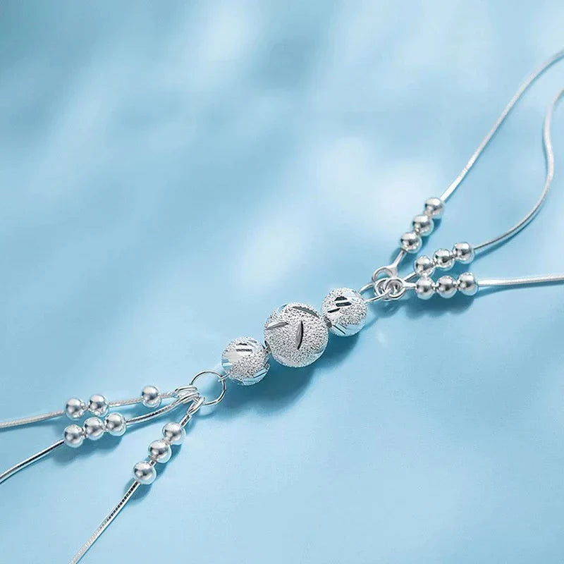 Silberne Armbandkette mit Kugelanhänger, elegantes Schmuckdesign, Damenaccessoire.