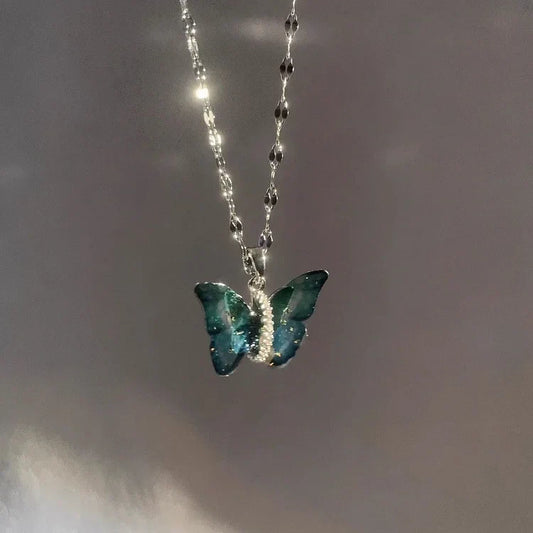 Silberne Schmetterlingskette mit blauem Anhänger, eleganter Schmuck, Damenaccessoire.