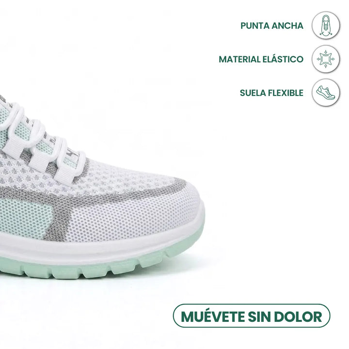 Nærbillede af den brede tå på den hvide og mintgrønne sneaker med ikoner for elastisk materiale og fleksibel sål. 14