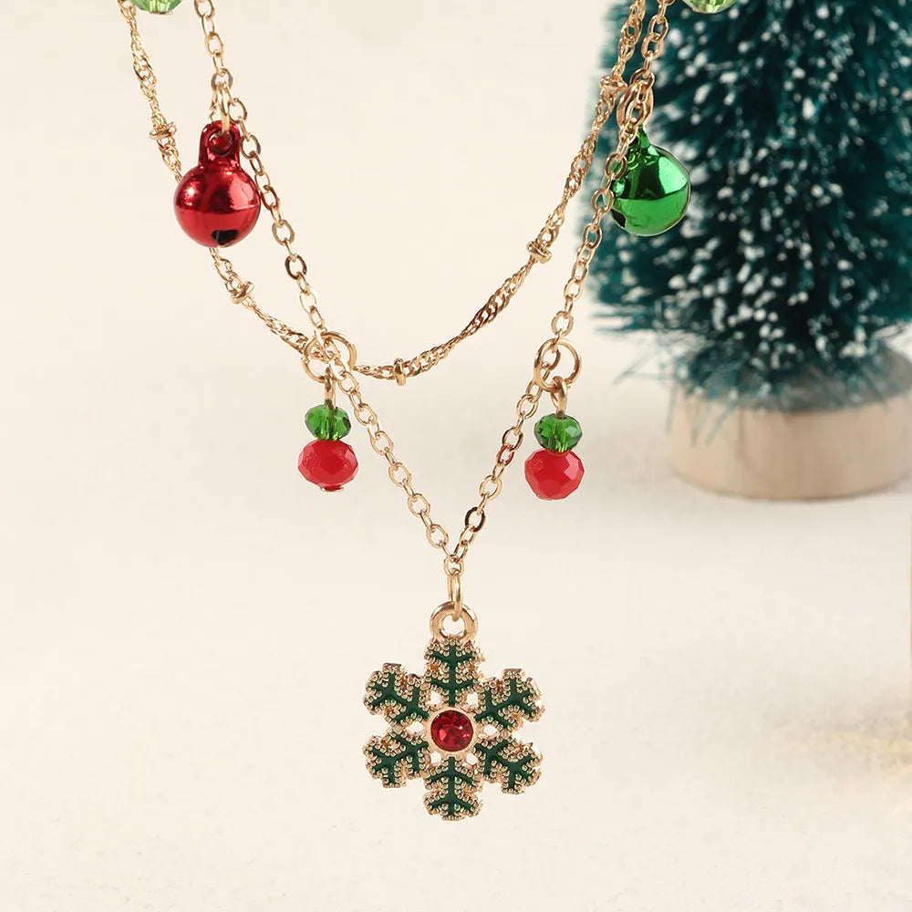 Goldene Halskette mit Schneeflocken-Anhänger, roten und grünen Perlen, Weihnachtsdesign.