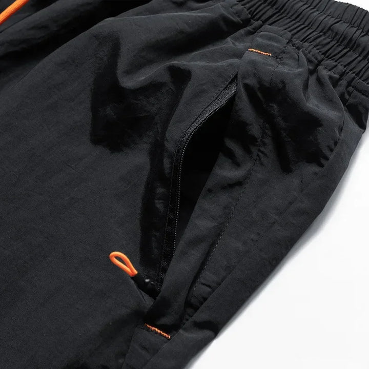 Løbeshorts til herrer med mesh-indershorts og lommer med lynlås – Nikoas