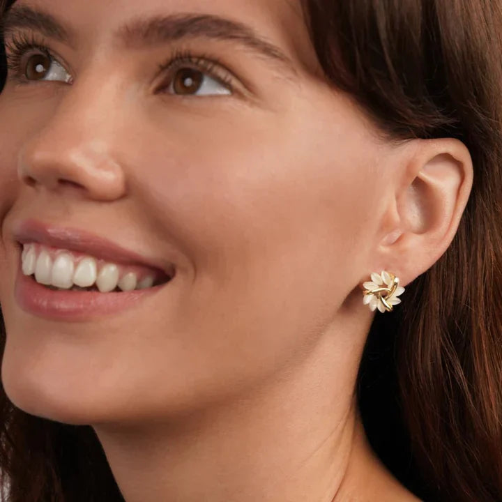 Frau mit goldenen Blumenohrringen, eleganter Schmuck, modisches Accessoire, Nahaufnahme.