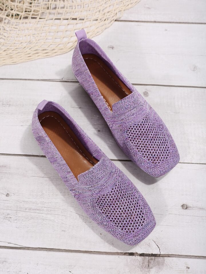 Et par lilla mesh slip-on sko set oppefra på lyst trægulv, med brun indersål og hælstrop. 13