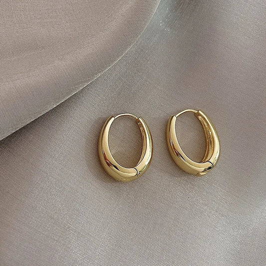 Goldene Creolen Ohrringe, glänzend, elegant, Schmuck, Damenaccessoire, modisch, zeitlos.