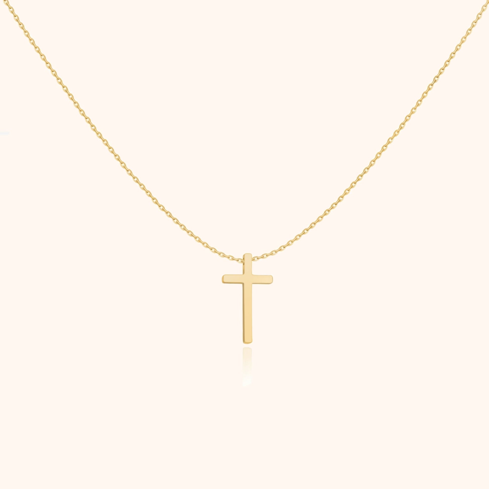 Goldene Kreuzkette, minimalistisches Design, eleganter Schmuck, religiöses Accessoire, Damenmode.