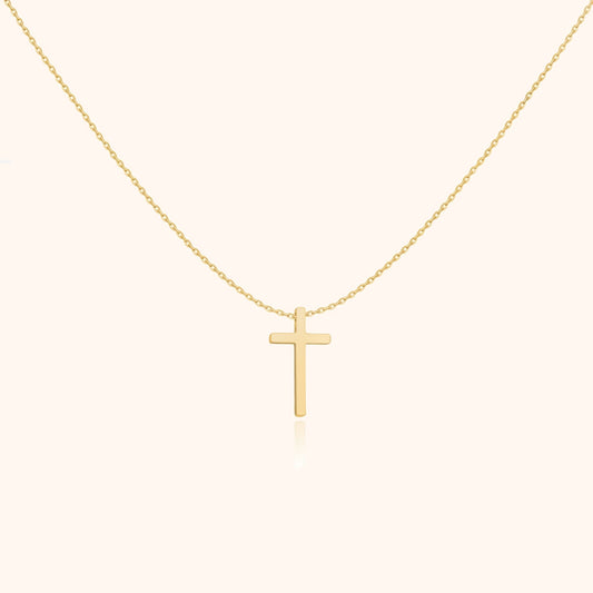 Goldene Kreuzkette, minimalistisches Design, eleganter Schmuck, religiöses Accessoire, Damenmode.