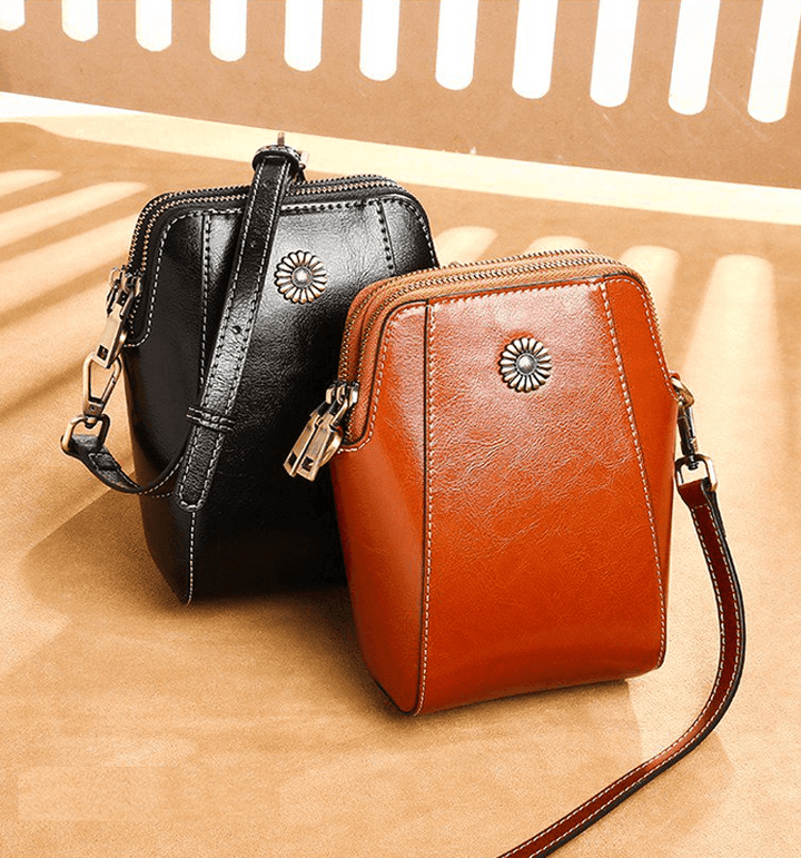 Mini læder crossbodytaske med blomsterdetalje - Liora