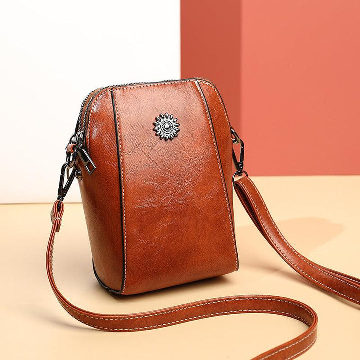 Mini læder crossbodytaske med blomsterdetalje - Liora