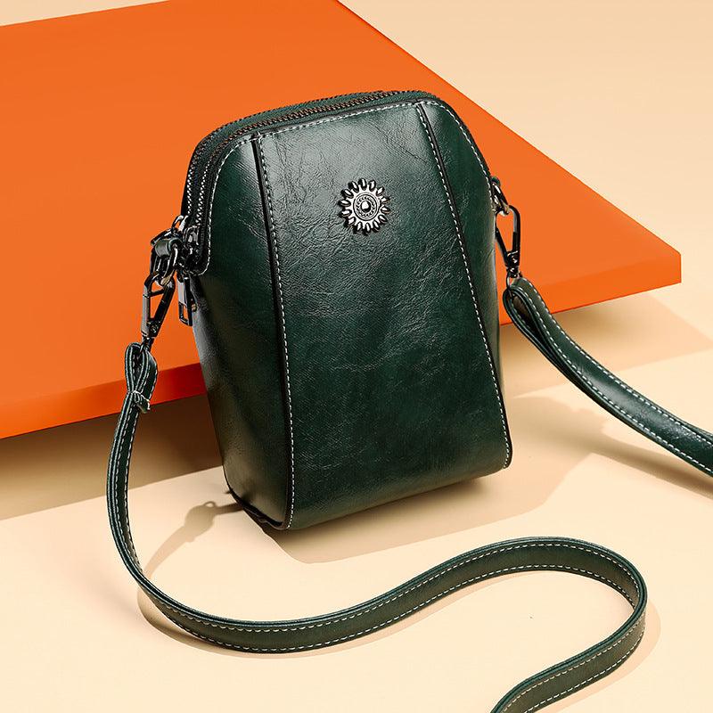 Mini læder crossbodytaske med blomsterdetalje - Liora