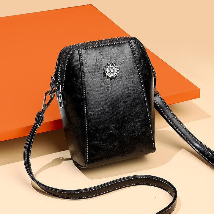 Mini læder crossbodytaske med blomsterdetalje - Liora