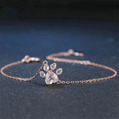 Rosenvergoldetes Armband mit Pfotenanhänger, Kristallsteine, eleganter Schmuck für Damen.